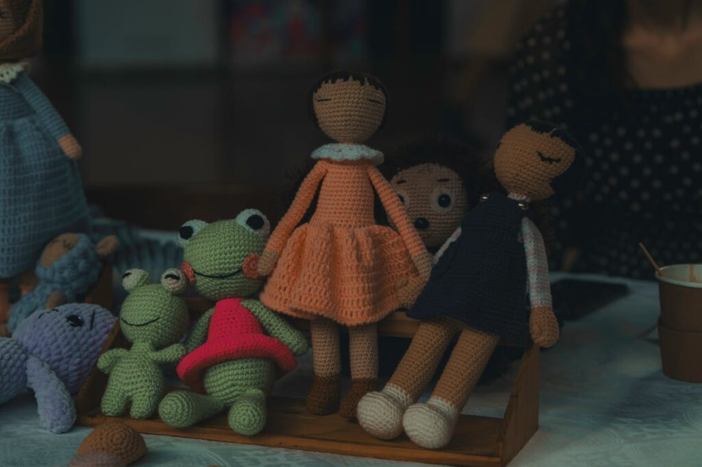 The Art of Drawing Readers In: Your attractive post title goes here A delightful set of handmade knitted dolls and stuffed animals on display, showcasing intricate craftsmanship.