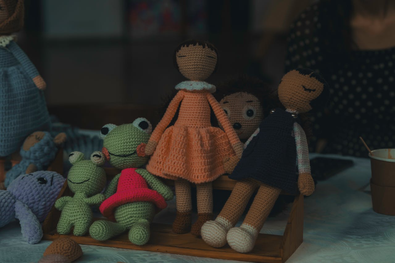 The Art of Drawing Readers In: Your attractive post title goes here A delightful set of handmade knitted dolls and stuffed animals on display, showcasing intricate craftsmanship.